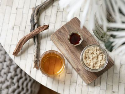 overhead shot of diy lip scrub with vanilla extract, honey, and brown sugar on tiled table