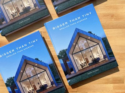'Bigger Than Tiny' books sitting on a wooden surface.