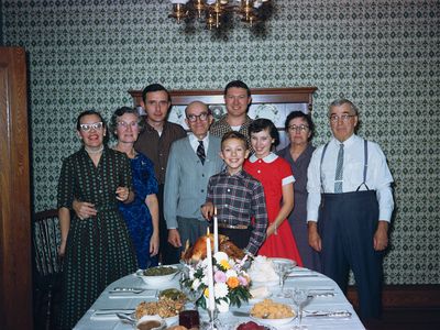 vintage throwback 1950s family portrait taken in front of holiday dinner table display