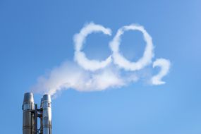 Smoke of chimney writing CO2 in the sky