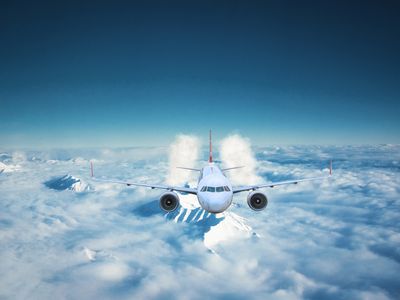 Passenger airplane flying above the clouds